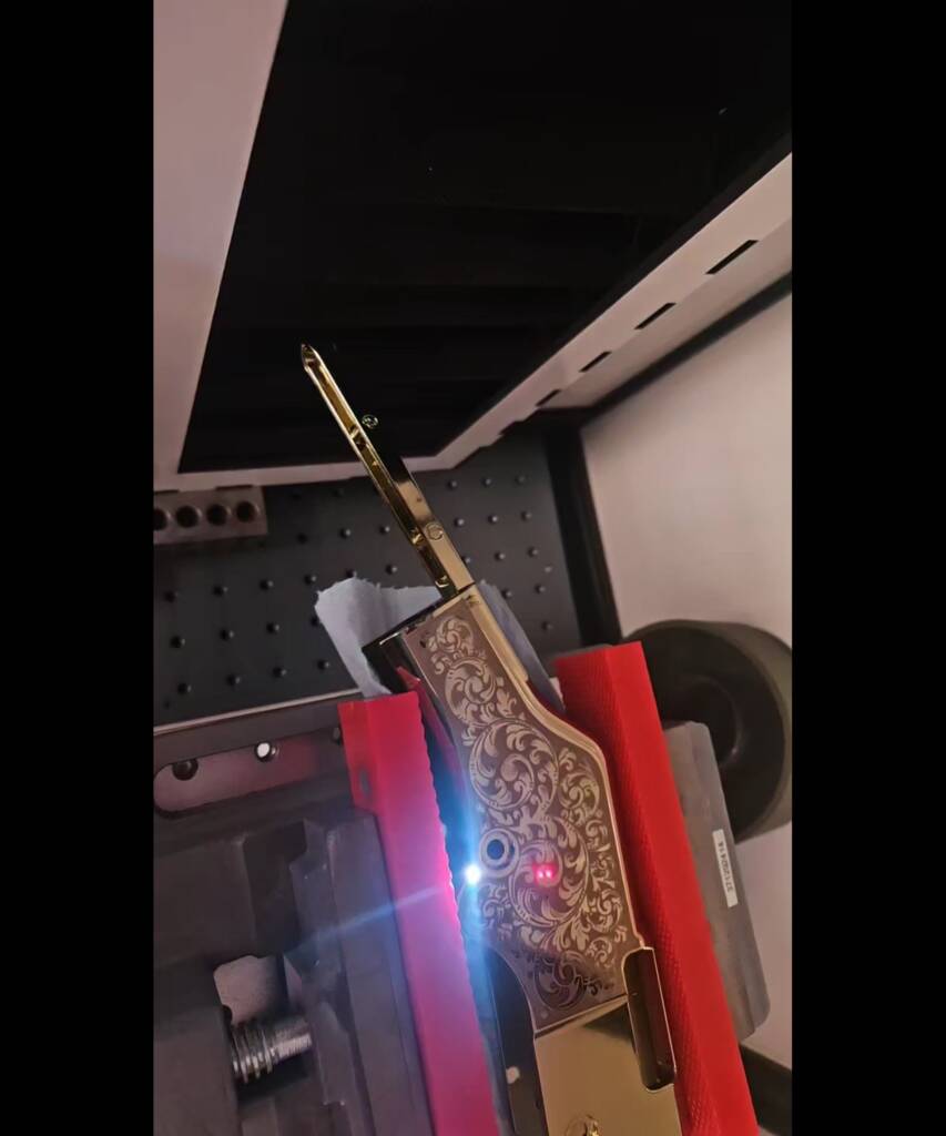 Ornate scroll engraving on a Henry rifle receiver, cut on the laser at Odell Arms in Mesa, Arizona